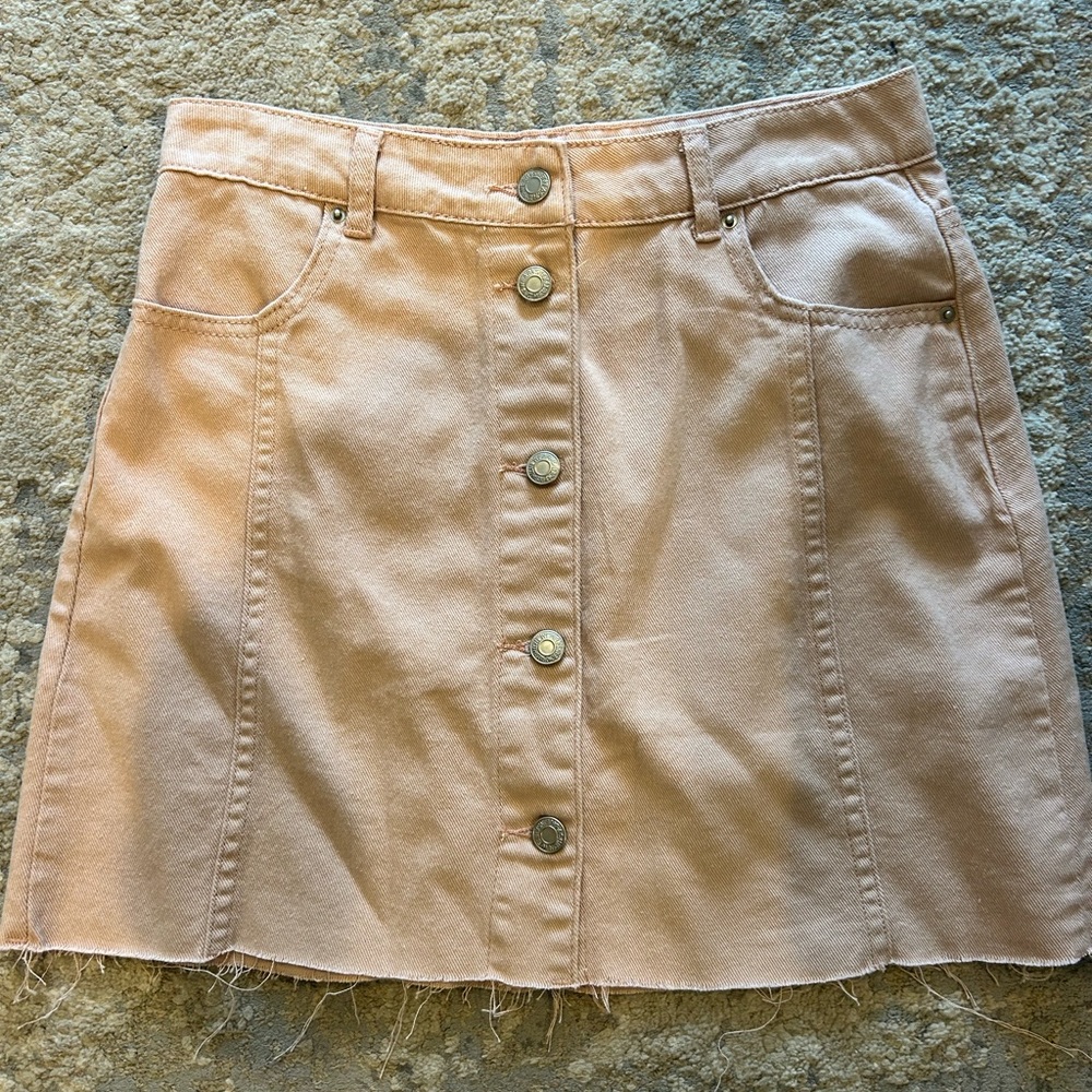 Light pink, functional button skirt.